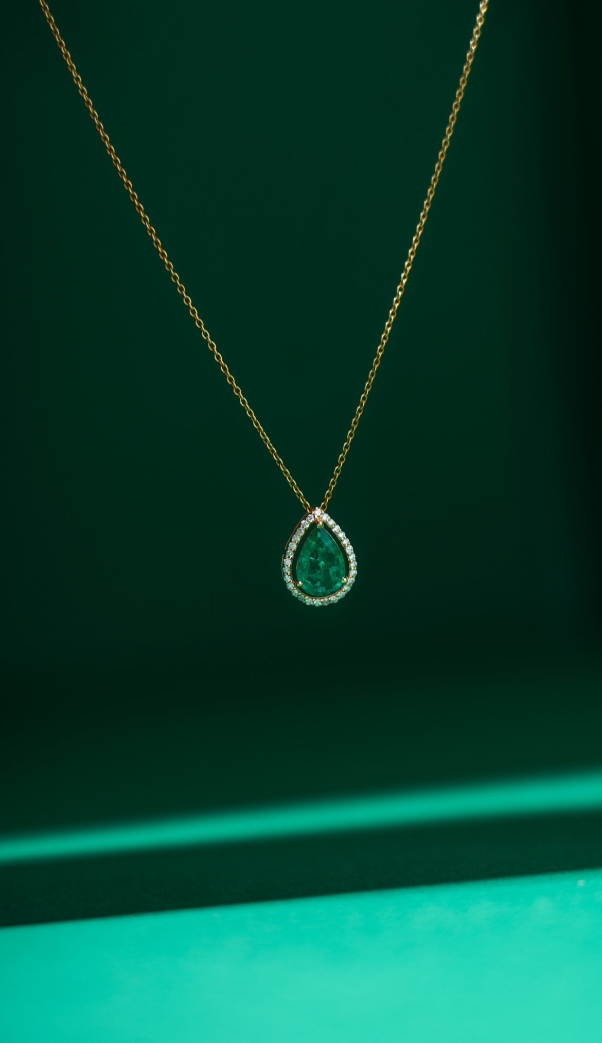 Emerald pear halo necklace